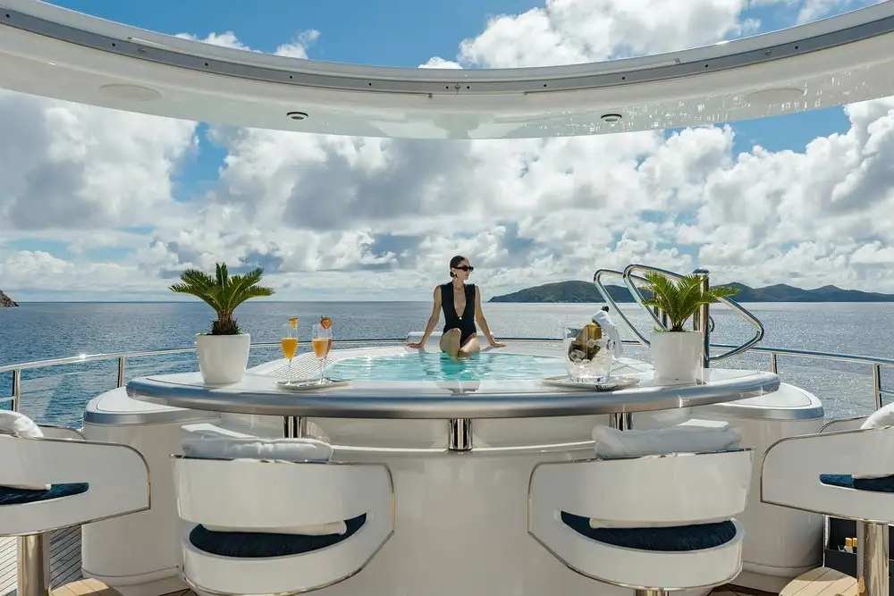 Luxury spa pool and seating area on a superyacht deck with ocean views