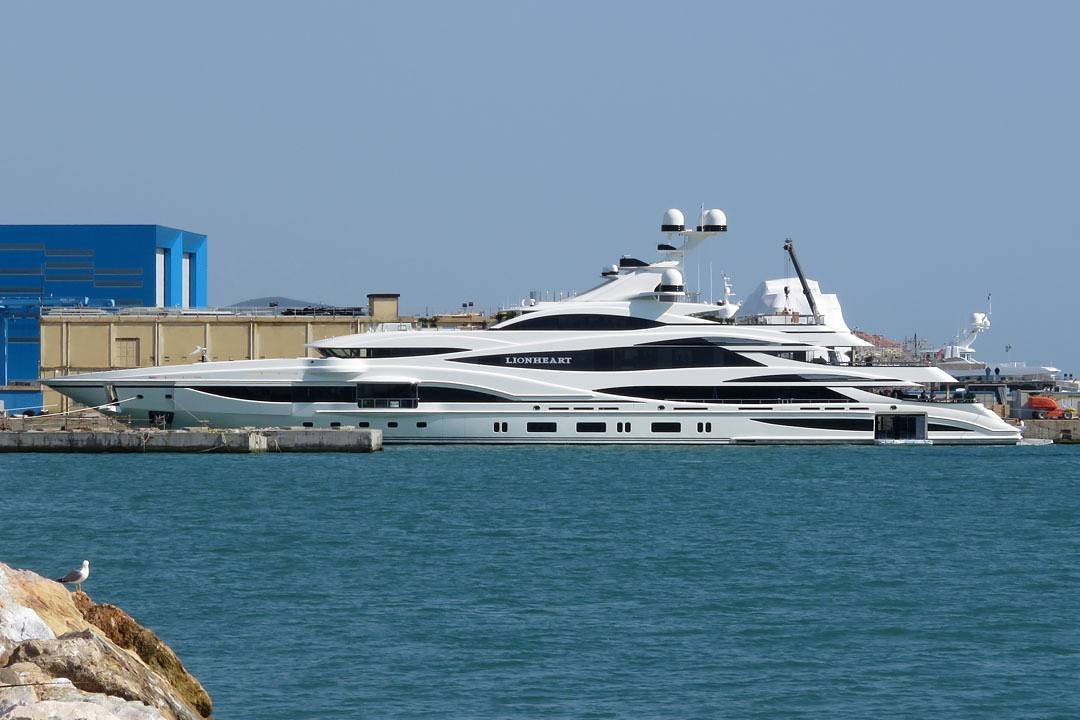 The 90-meter superyacht Lionheart, associated with Philip Green, docked at harbor showcasing its sleek design and luxury features
